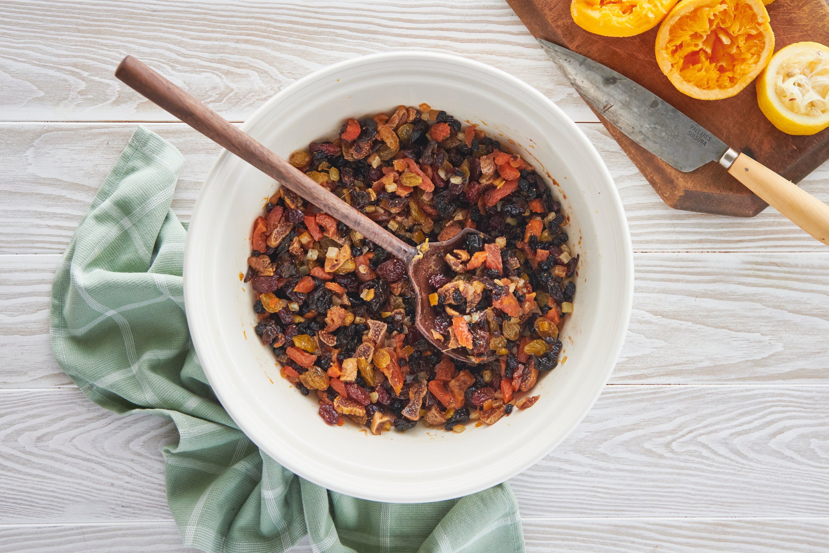 A bowl full of Christmas Cake fruit soaking in juice and brandy