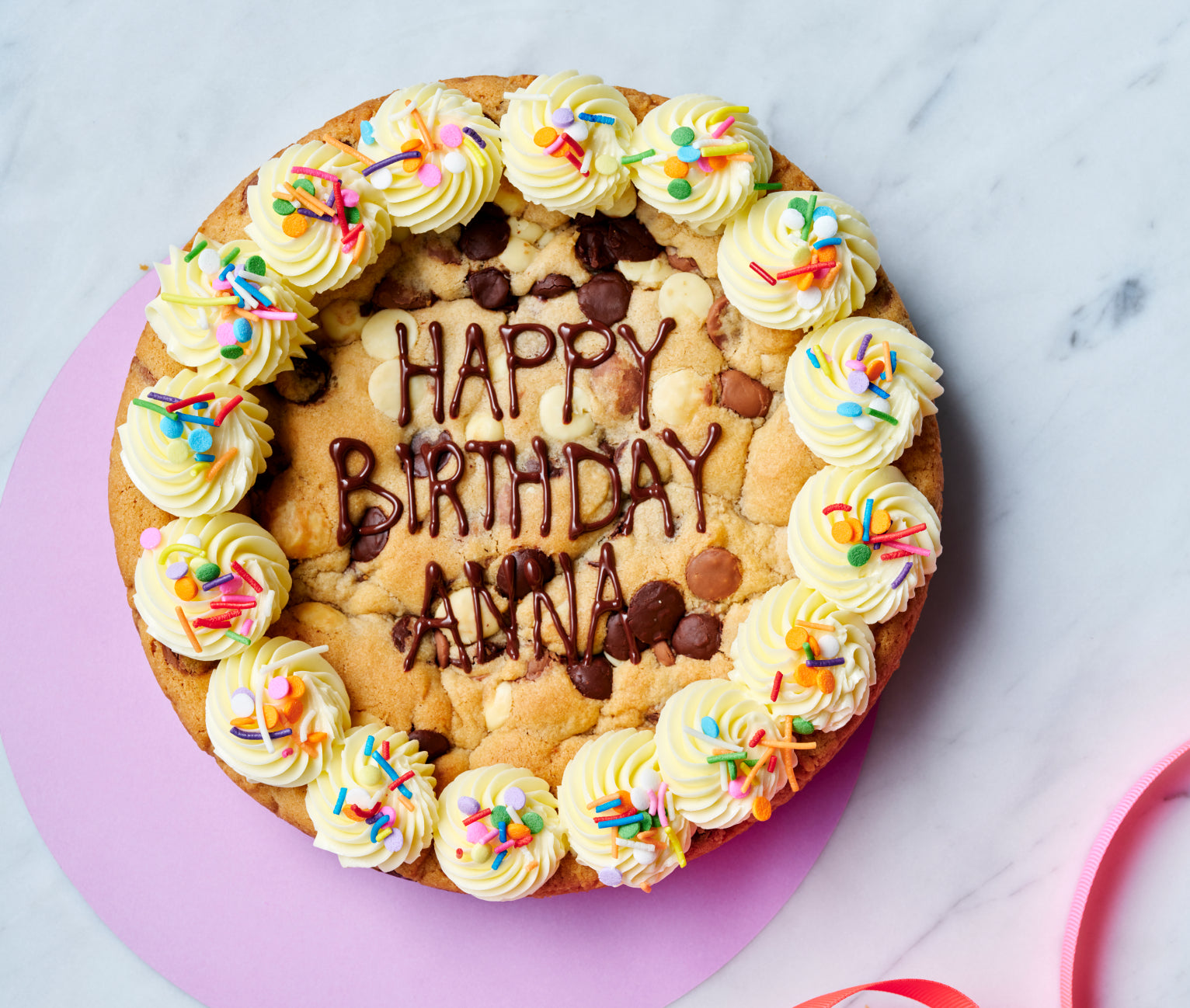 A cookie birthday cake with buttercream decorations