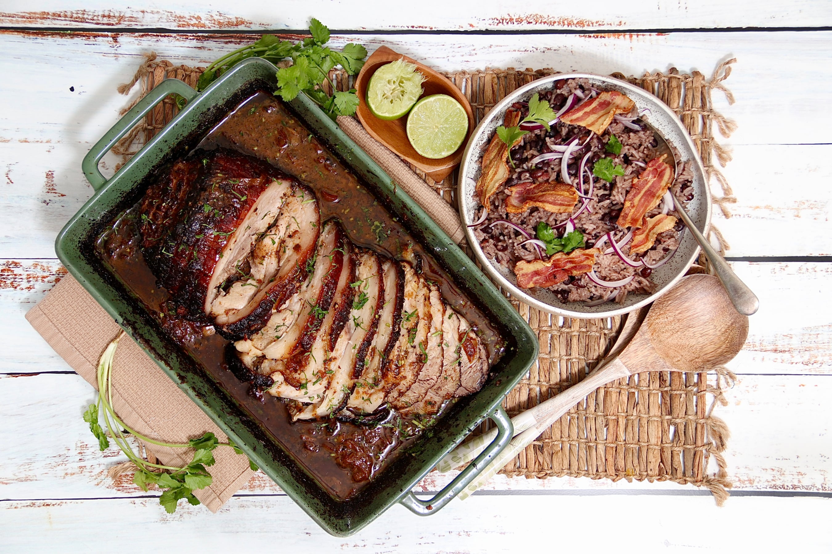 Slow Roasted Cuban Style Mojo Pork with a side on Congri Rice garnished with red onions, bacon and coriander.