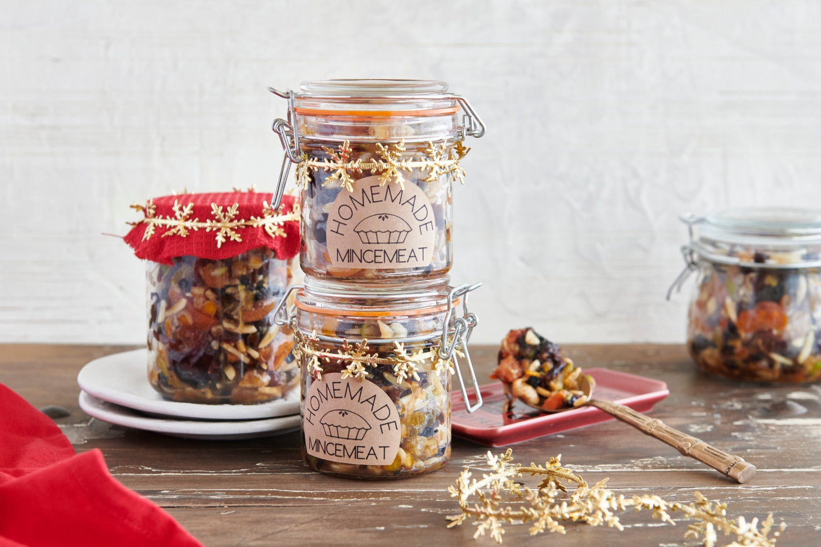 Jars of homemade fruit mincemeat for making mince pies at Christmas with gift labels