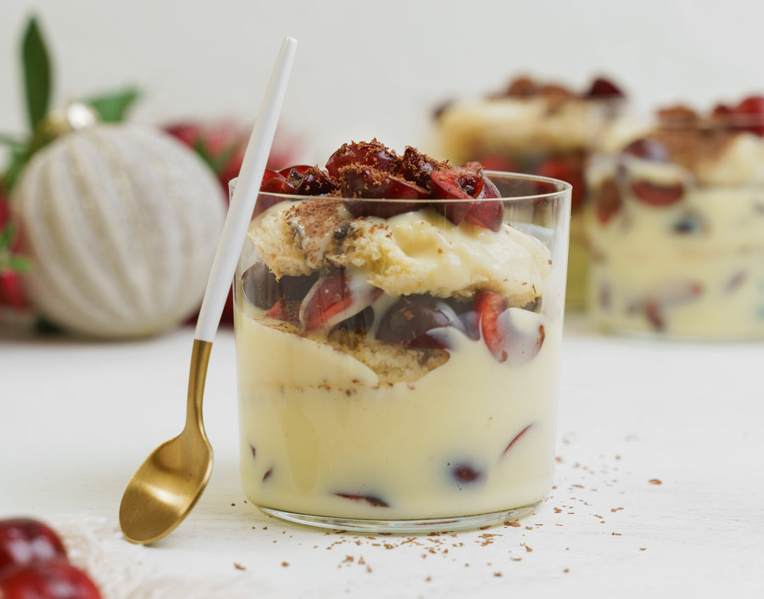 Trifle style layered desserts made in glasses using panettone, custard and cherries