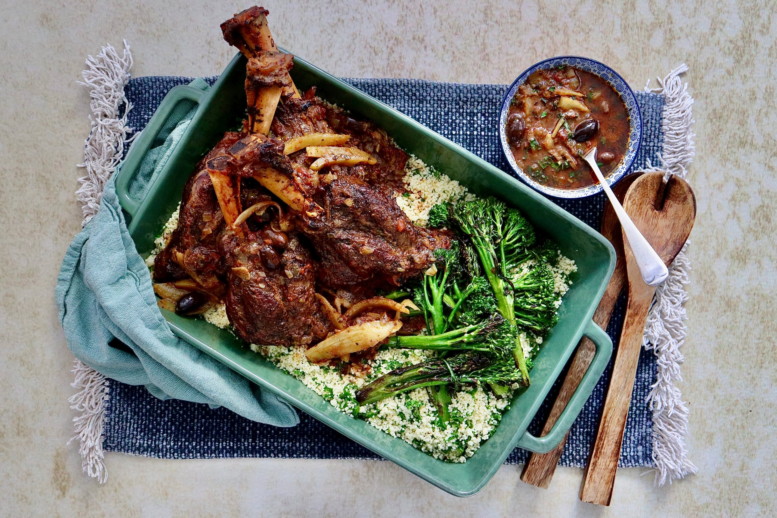 Moroccan style lamb shanks on a bed of herbed couscous and grilled broccolini