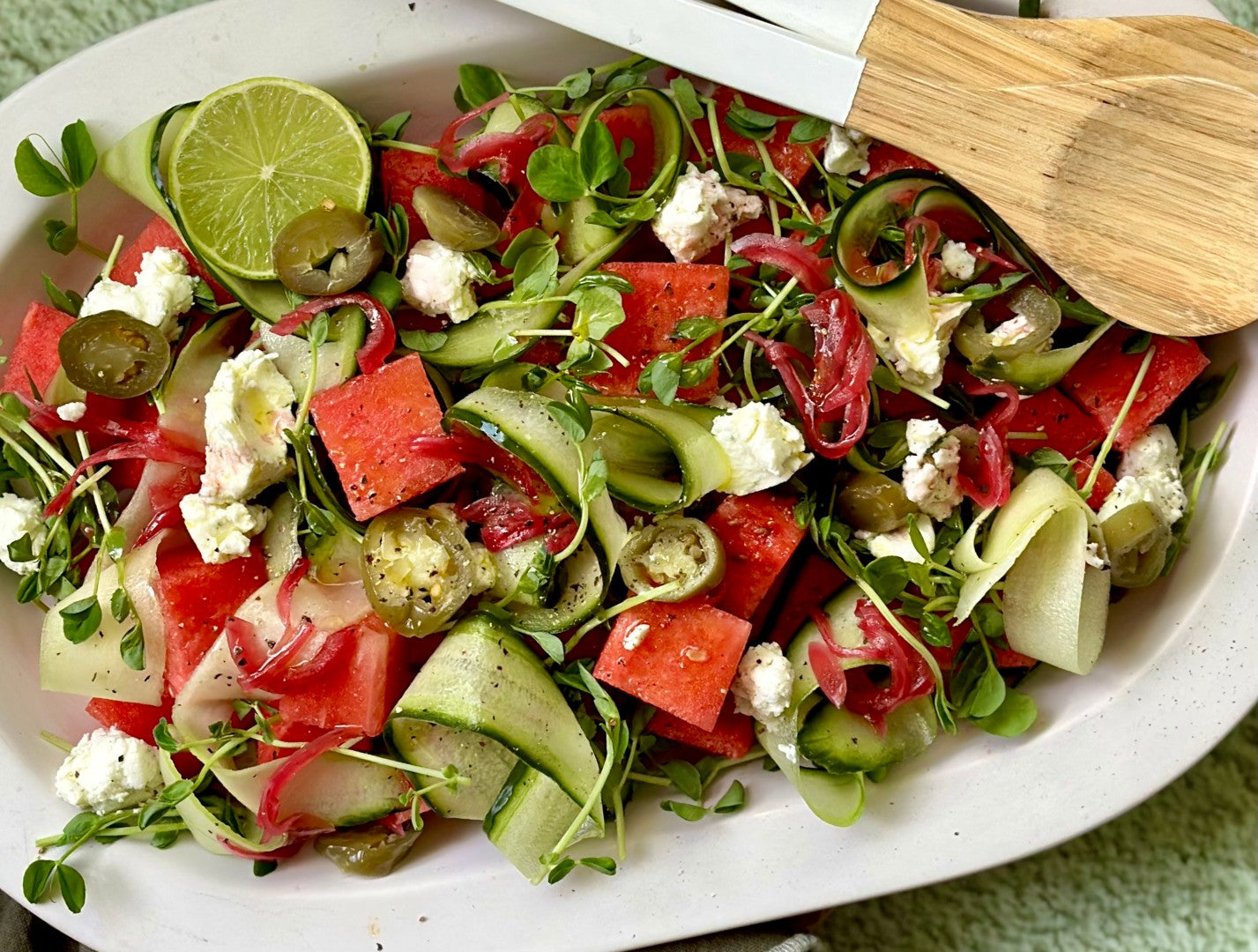 A dish of watermelon and cucumber salad with feta and peppers