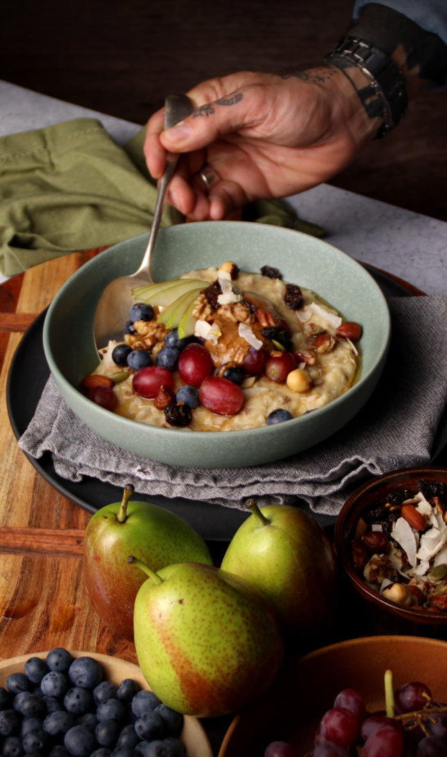 Creamy Porridge with Mixed Nuts, Seasonal Fruit, Almond Butter & Coconut Syrup
