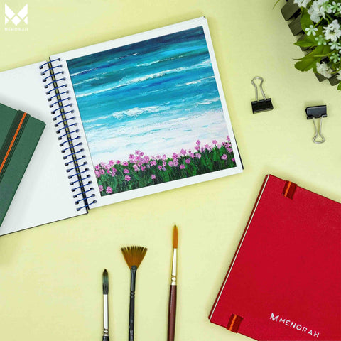 Cool sea view painting using watercolor, Paintings of a beautiful beach with a full of flowers using watercolor, Beach paintings in watercolor sketchbook, Watercolor sketchbook is made of 100% cotton and is 100% Vegan. It contains 40 pages with a 300GSM Thickness so that watercolor won't penetrate to the other page. It is covered by Metal spiral with 360 Degree easy turn. Make your creations by using watercolour paintings, Acrylics, Gouache, Tempera, Poster colour in this sketchbook