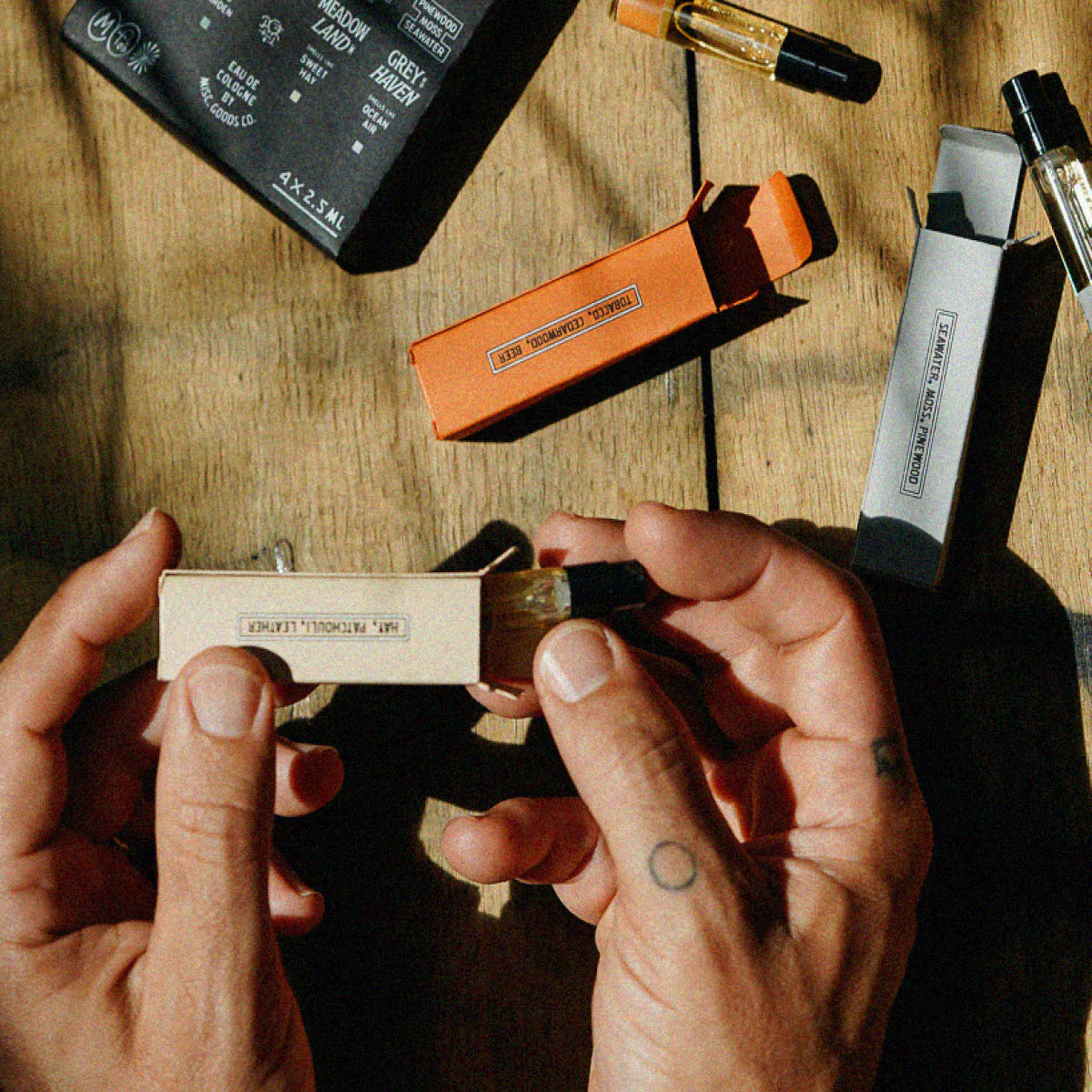 A person samples fragrances from Misc. Goods Co.’s Discovery Eau De Cologne Set.