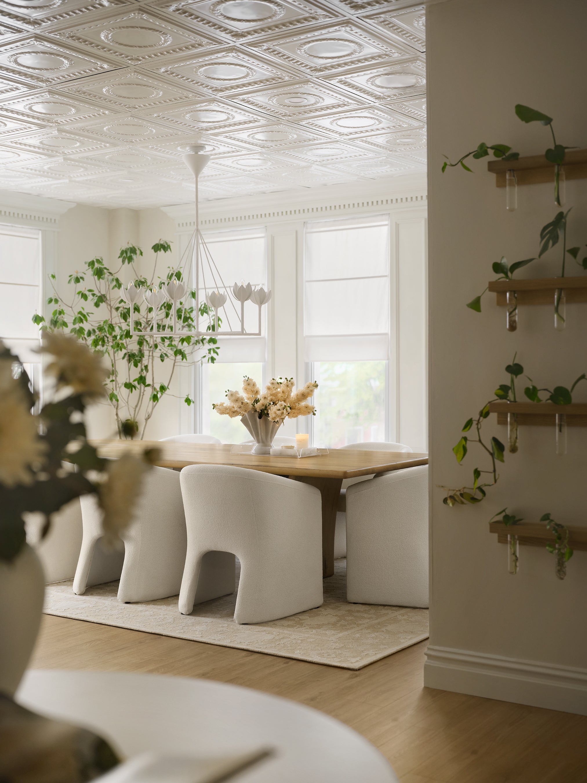 he conference room featured on Mini Reni: Hoda's Inspiring New Office—complete with a long wooden table, white chairs, a neutral rug, plants, and more from Magnolia.