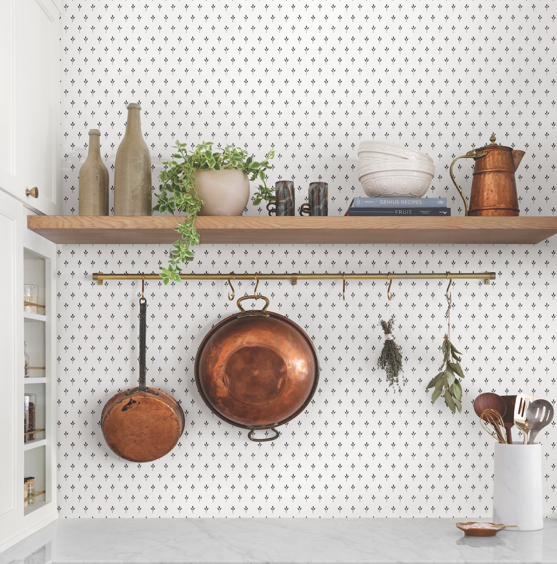 Decorated kitchen shelving against patterned wallpaper