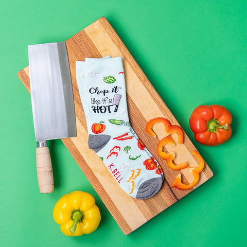 Cute women's food socks on a cutting board with a knife and vegetables