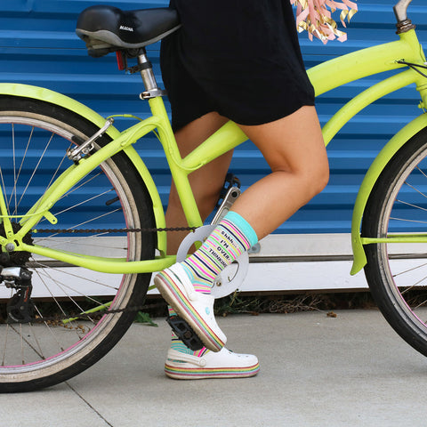 Sock Fairy Lindsay on the shop bike, along with cute socks and Crocs!