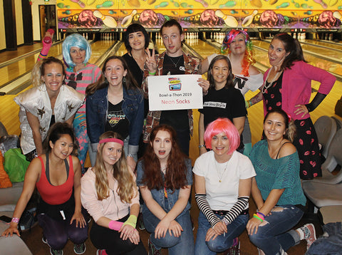 The Sock Drawer staff wearing '80s costumes at a bowling fundraiser for TMHA