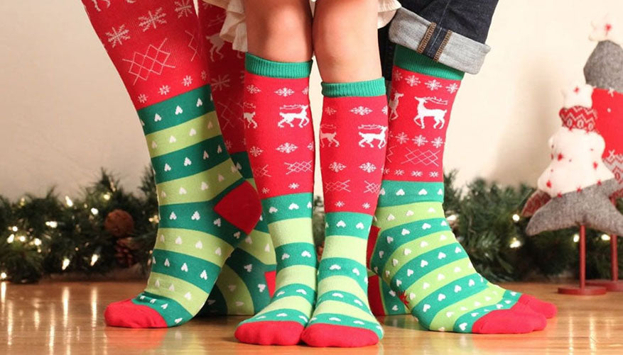 family wearing matching holiday themed socks