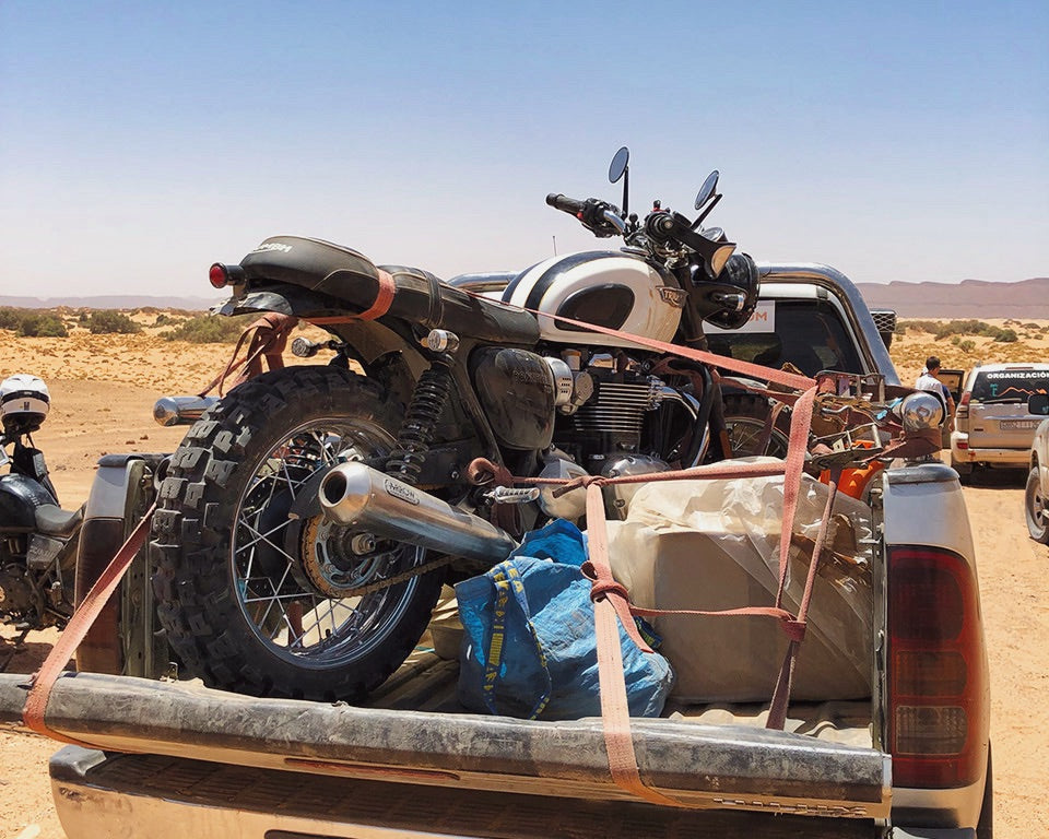 Broken motorcycle on the pickup truck bed