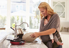 Mom Washing Dishes with Baby Napping in Carrier