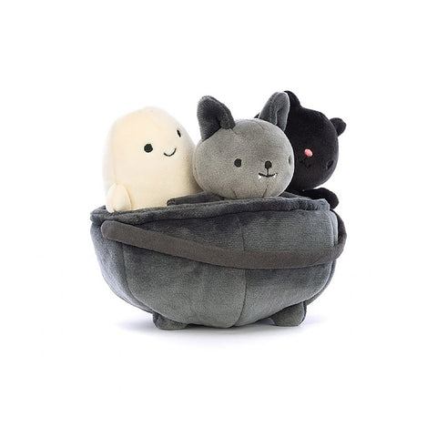 Three stuffed Jellycat toys in a cauldron including a bat ghost and cat