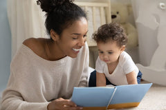 Mom Reads Story to One-year-old Baby