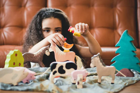 child playing with holtztiger wood toy animals