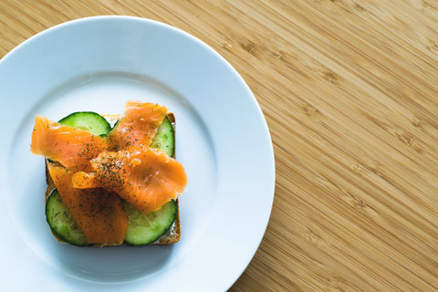 Cucumber slices with smoked salmon on a toast