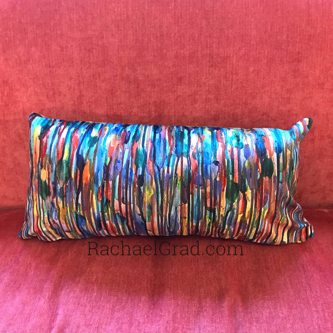 abstract multicolor pillow on pink couch by artist rachael grad