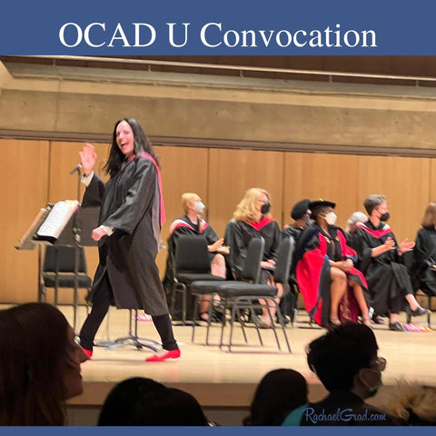 Rachael Grad walking across Roy Thomson Hall stage at OCAD U convocation