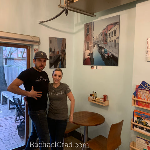 Cristina and Enrique of CocoaLatte Toronto in front of artwork by Rachael Grad