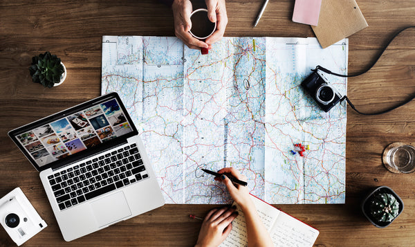 two friends planning a trip on a map