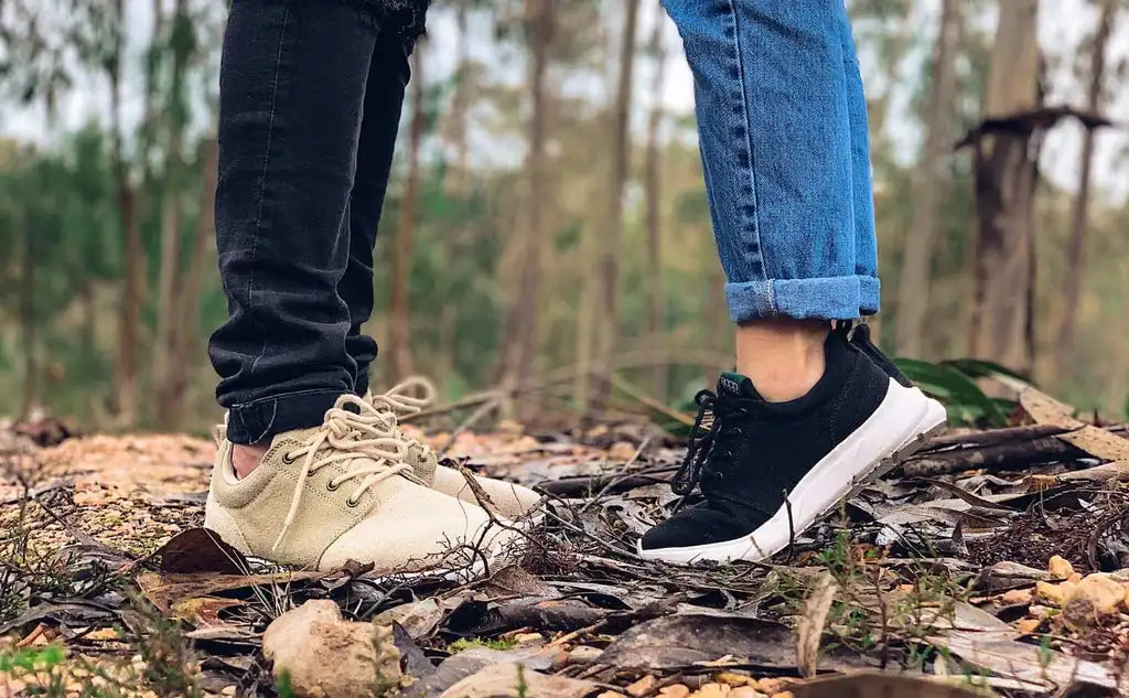 A young couple stand in the middle of a forest with their hemp shoes by 8000 Kicks
