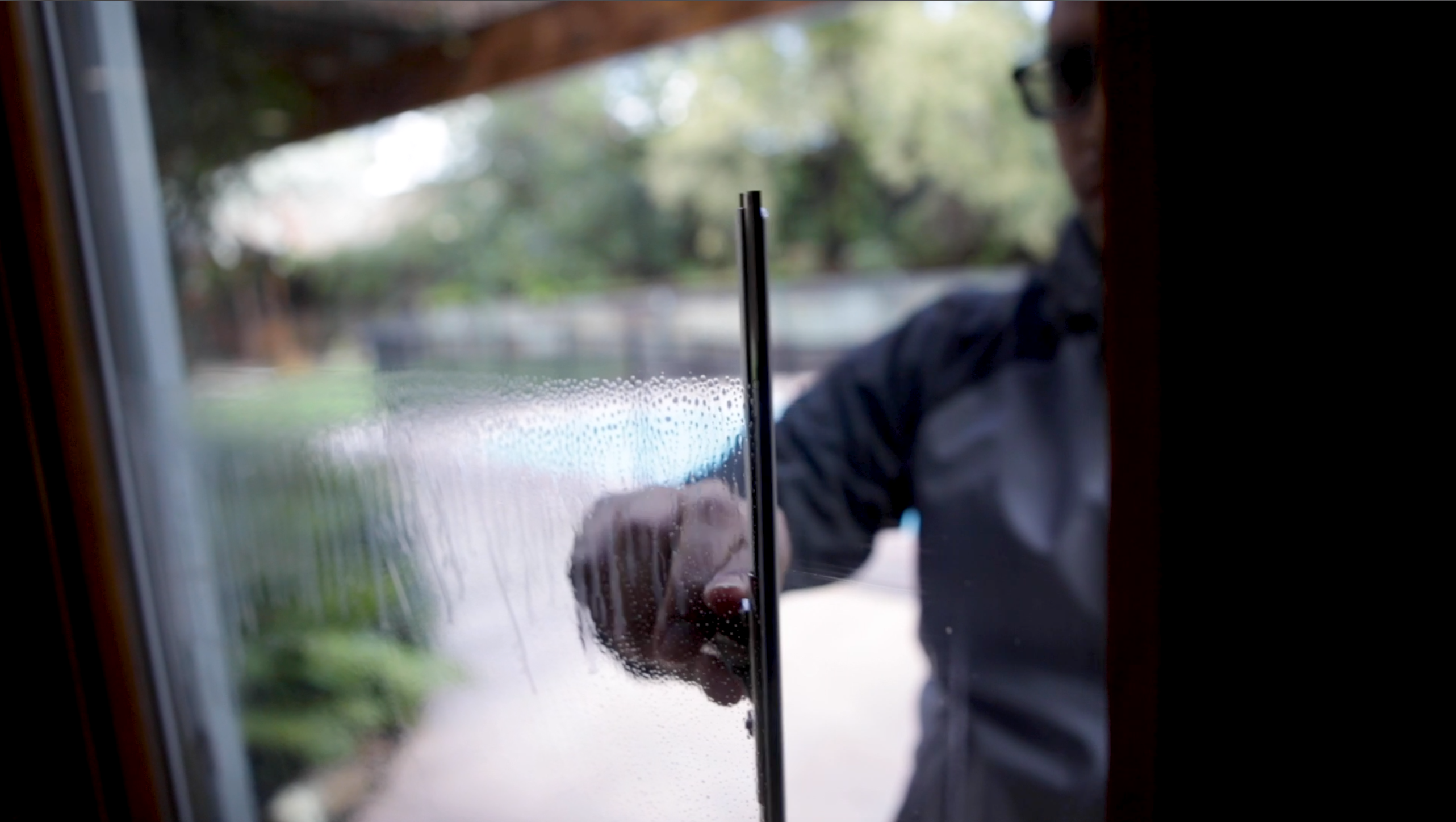 Brass Squeegee Wiping Window