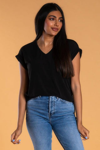 Woman wearing black blouse tee and jeans
