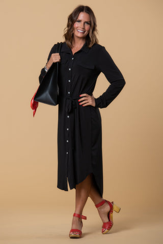 Woman wearing a black modest dress with buttons and long sleeves