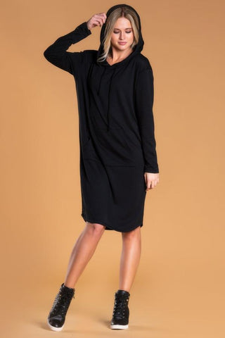 Woman wearing long sleeve black dress with hood 