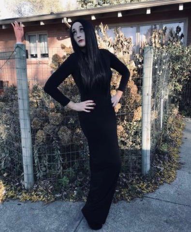 Woman with long black hair wearing a long black dress