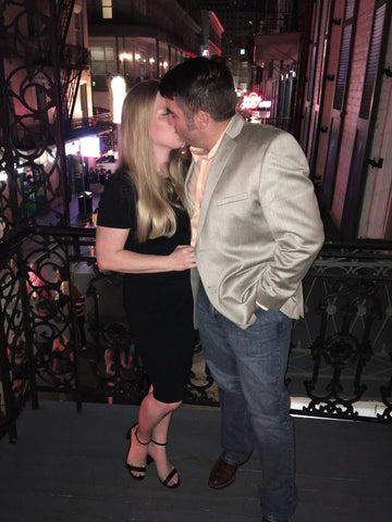 Woman wearing black dress and kissing a man