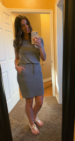 Woman posing for photo wearing gray baseball tee dress
