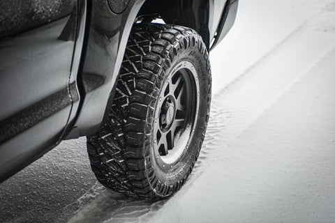 Shot of car tire on snowy road