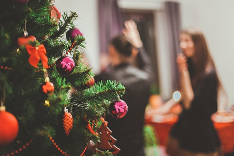 Close up of Christmas tree with people in the background