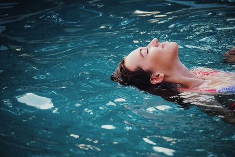 Woman floating on back in a swimming pool