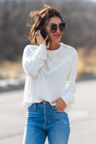 Woman wearing white lace sweatshirt