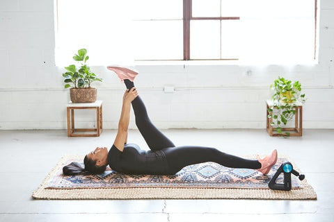 Woman exercising on mat at home