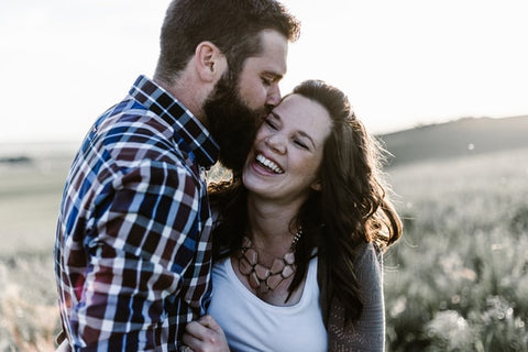 Man kissing a woman on the cheek