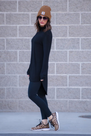 Woman wearing long sleeve top with leggings and a beanie