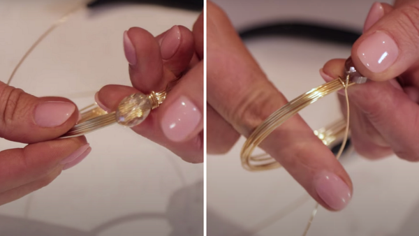 close up of stringing a bead onto a wire bangle 