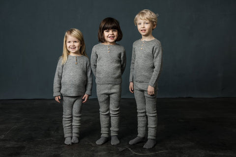 3 children of different ages wearing As We Grow jumpers for different purposes