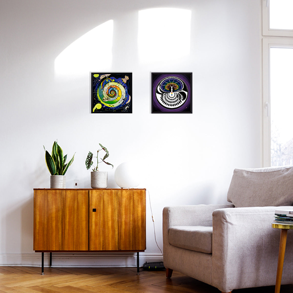 two framed prints of moon goddess images in a spiral and a circle