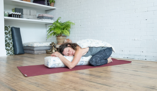 childs pose with a bolster