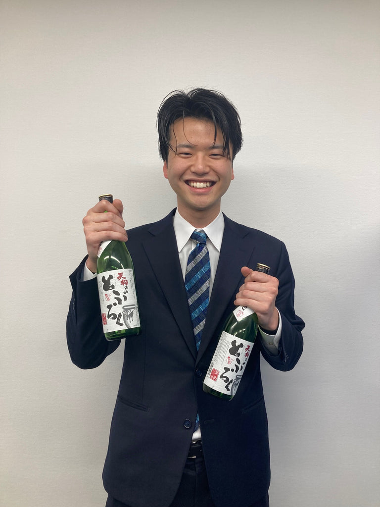 Ryuta Nakashima of Koyama Honke with Tengu no Toburoku bottles.