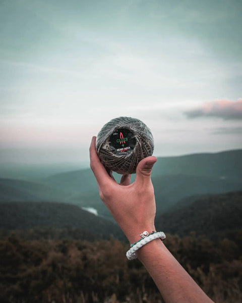 A person holding a roll of Gleeb hemp wick