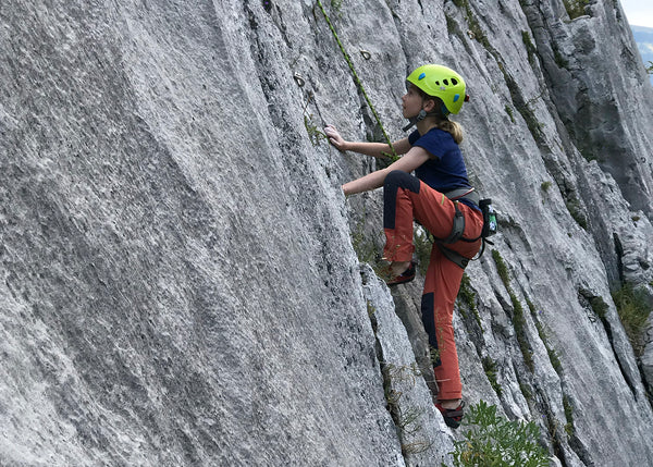 Child climbing wearing a climbing helmet