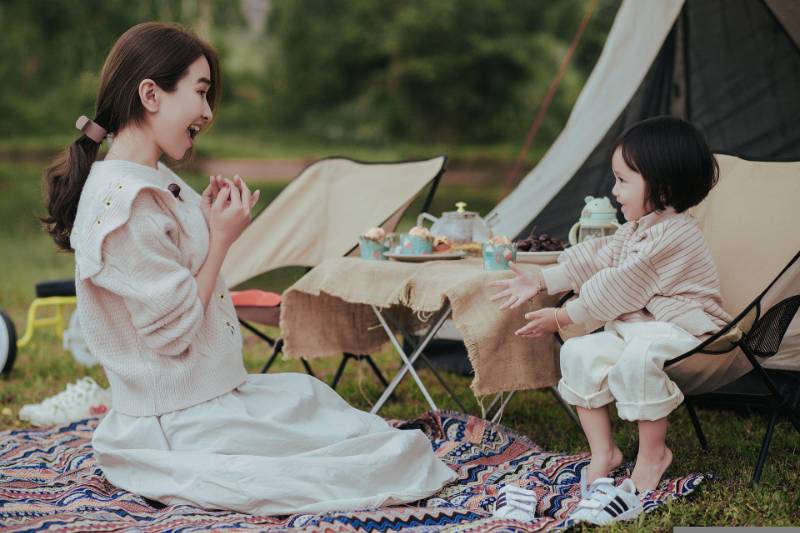 Mother and daughter camping and playing