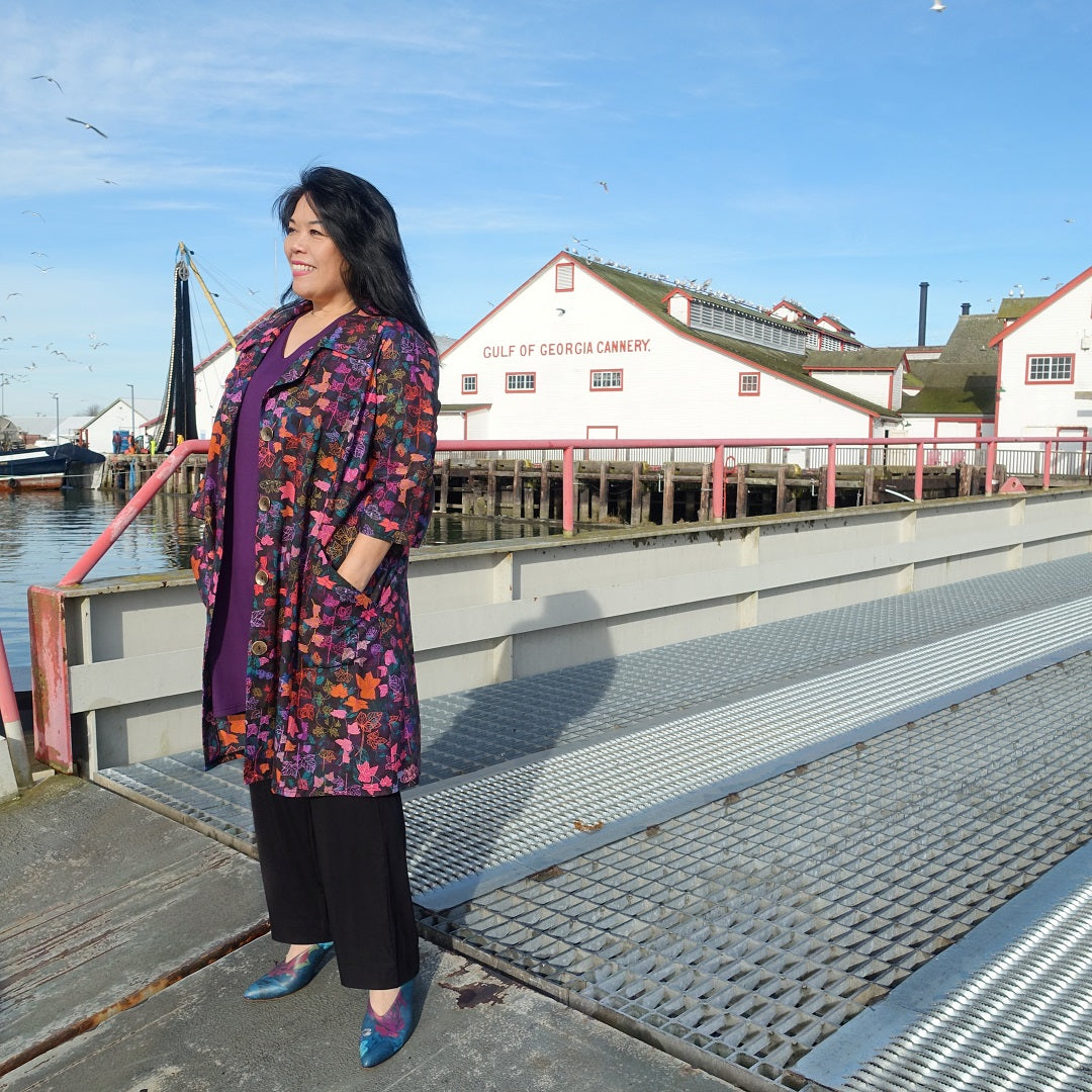 Model poses in front of a historic Steveson Cannery in an outfit by Canadian designer Diane Kennedy